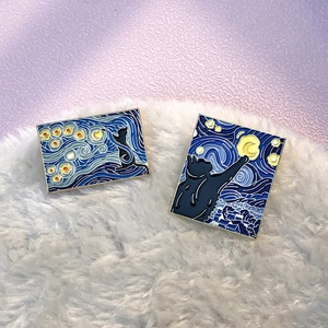 Starry Night oil painting enamel brooches featuring black cats on soft white plush surface