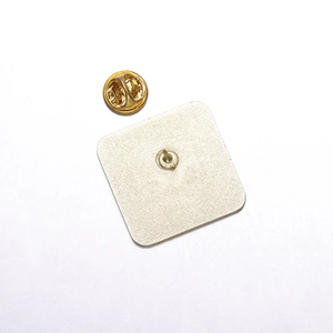 Macro shot of the square metal pin back with golden finish and butterfly clutch backing