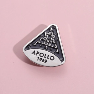 Apollo 1969 moon landing commemorative enamel pin in black triangular metal badge design
