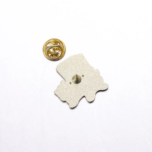 Detailed close-up of golden metal butterfly clutch and pin back for enamel pins