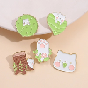 Set of five cute cartoon cat enamel pins with green leaves and pink paw designs