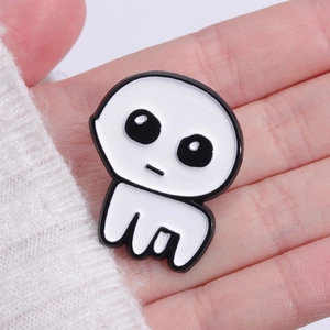 Handheld view of a cute white ghost enamel pin with black details for Halloween
