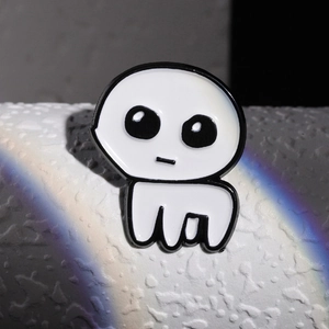 Close-up of white enamel ghost creature badge with black outline and rainbow light effect