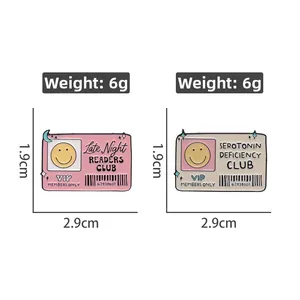 Detail view of pink and beige ID card enamel pins with size and weight dimensions