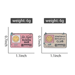 Detailed view of pink and white enamel badges with size specs and metal buckle back
