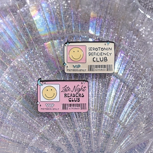 Creative enamel pins set featuring cartoon club designs and yellow smiley face badges