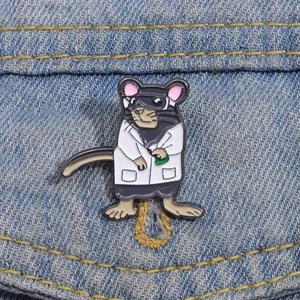 Detail of creative mouse enamel pin in lab coat on denim fabric, scientist cartoon style
