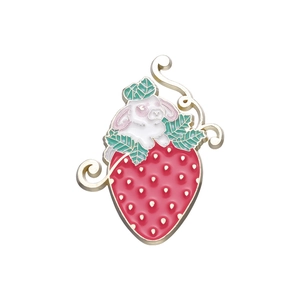 Creative enamel brooch featuring a cute white rabbit on a large red strawberry with gold trim