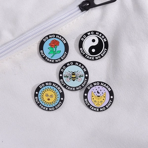 Detailed close-up of five round enamel pins with inspirational quotes on white canvas bag