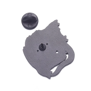 Detail view of the metal brooch back with textured finish and black rubber clutch back
