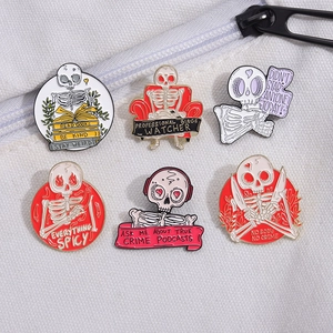 Set of six punk skeleton enamel pins with creative cartoon designs on white fabric