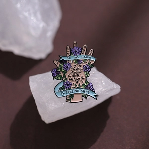 Artistic hand enamel brooch with purple flowers and inspirational quote ribbons