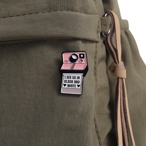 Spilla in smalto a forma di fotocamera rosa con citazione su borsa in tela verde