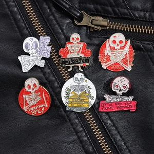 Detailed view of six punk skeleton enamel pins styled on a black leather jacket texture