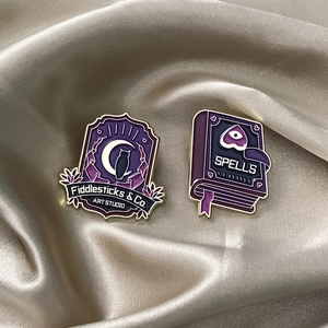 Magic Academy enamel pin set featuring purple owl shield and spells book on silk background