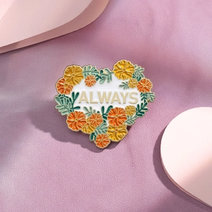 Heart shaped enamel flower pin with Always text and gold floral motifs on purple base