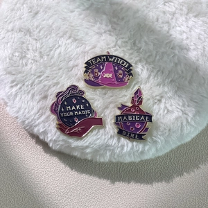 Three-piece purple enamel pin set featuring witch hat, crystal ball, and magic bottle designs
