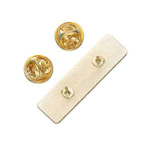 Detail view of gold metal pin backings and rectangular base with butterfly clasps