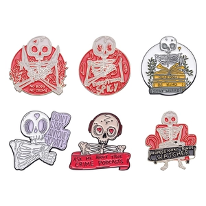 Set of 6 skull enamel pins with creative slogans like No Body No Crime and Stay Weird