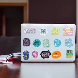 Waterproof inspirational quote stickers applied to a white laptop for DIY decoration