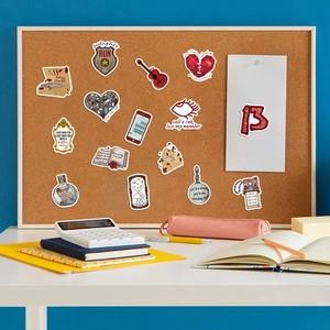 Detailed close-up of music-themed waterproof stickers displayed on a cork board setup