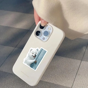 Detail of cream silicone phone case with hand-drawn Samoyed peeking behind door