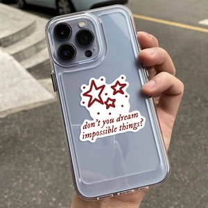 Close-up of clear phone case featuring red stars and artistic handwritten slogan text