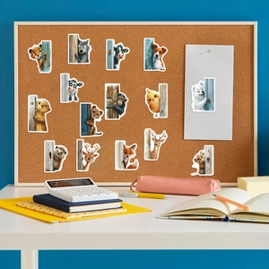 Detail of 15 cute cartoon animal peeking stickers displayed on a cork board setting