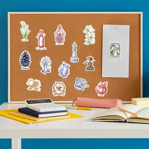 Vintage hand-drawn stickers with botanical and lifestyle patterns on a cork board display