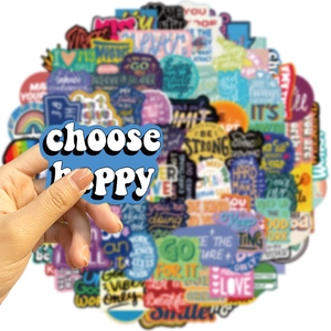 Close-up of hand holding a waterproof colorful motivational sticker with positive quotes