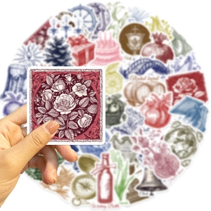 Close-up of hand holding a vintage rose sticker from a 50-piece waterproof art set
