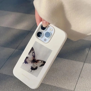 Creamy white iPhone case featuring a detailed black butterfly print and matte texture