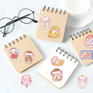 Autocollants d'axolotl rose mignons sur des carnets avec café et lunettes de vue