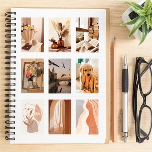 Detail van warme beige stickers met bloemen- en architectuurmotieven op een notitieblok