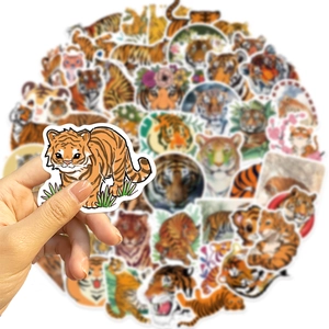 Close-up of a cartoon tiger sticker being held with a variety of blurred stickers behind