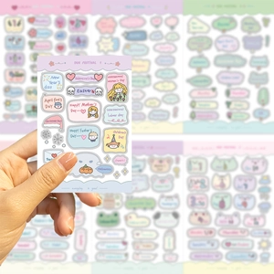 Detailed close-up of cartoon holiday planner stickers for journals and DIY decor