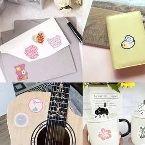 Detail shots of pink decorative stickers on envelopes, journals, and water bottles