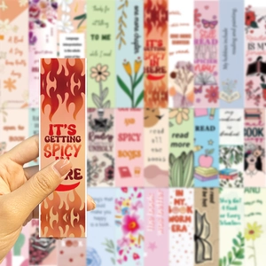 Hand holding a creative illustrated bookmark featuring spicy book theme and floral designs