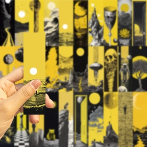 Close-up of artistic yellow and black bookmarks with astronaut and geometric illustrations