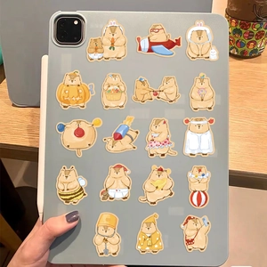 Waterproof cartoon capybara stickers in various costumes applied on a tablet back