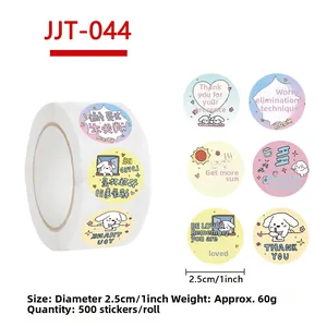 Close-up of 500 count dog stickers roll with 1 inch cute cartoon puppy patterns