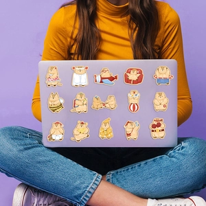 Close-up of waterproof cartoon marmot stickers on a purple laptop back surface