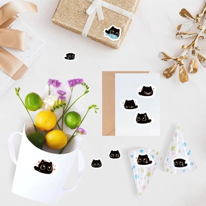 Detail of cute black cat emoticon stickers used for gift boxes and stationery decoration