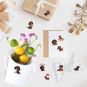 Detail of cute dachshund cartoon stickers decorating a white paper gift bag and envelope