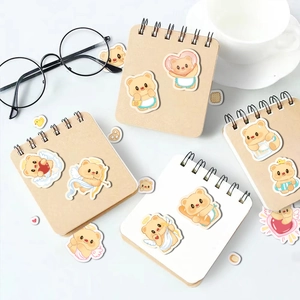 Cute Butter Bear stickers on a mini notebook with coffee cup and glasses setup