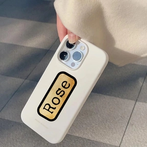 Close-up of vintage Rose print phone case held by hand showing retro cream aesthetic