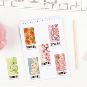 Floral bookmarks set with hand-drawn botanical illustrations on a white spiral notebook