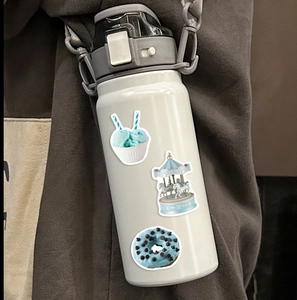 Close-up of mint green ice cream and carousel waterproof stickers on white bottle