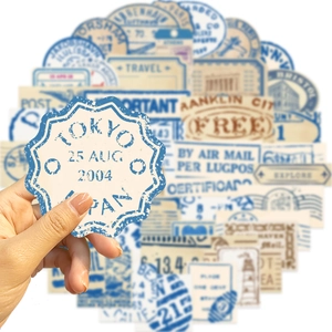 Close-up of hand holding vintage travel-themed waterproof wine label stickers