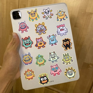 50 pieces of colorful cartoon monster stickers decorating a silver tablet back